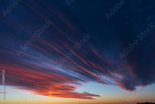 Stunningly beautiful multi-colored violet-pink-lilac evening sky  multi-colored clouds fan out from the lower horizon