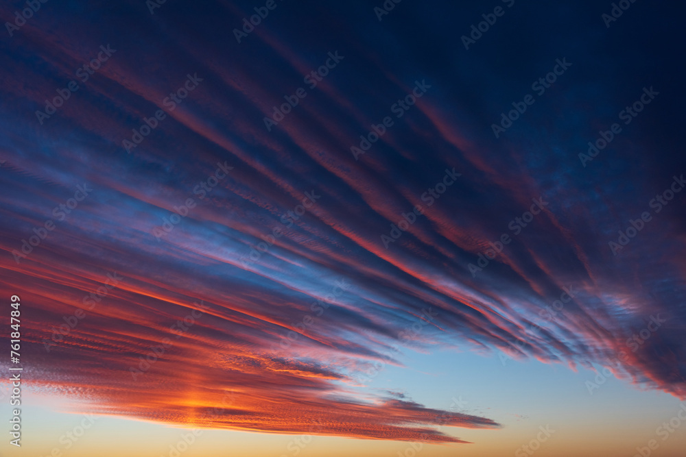 Stunningly beautiful multi-colored violet-pink-lilac evening sky, multi-colored clouds fan out from the lower horizon