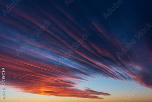 Stunningly beautiful multi-colored violet-pink-lilac evening sky, multi-colored clouds fan out from the lower horizon