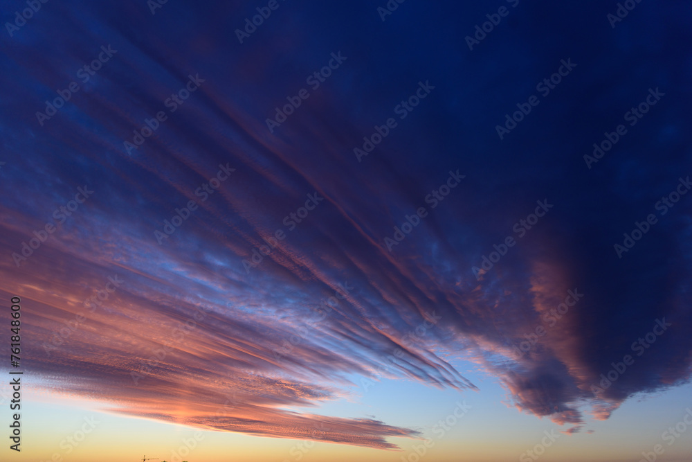 Obraz premium Stunningly beautiful multi-colored violet-pink-lilac evening sky, multi-colored clouds fan out from the lower horizon