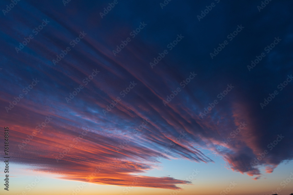 Stunningly beautiful multi-colored violet-pink-lilac evening sky, multi-colored clouds fan out from the lower horizon