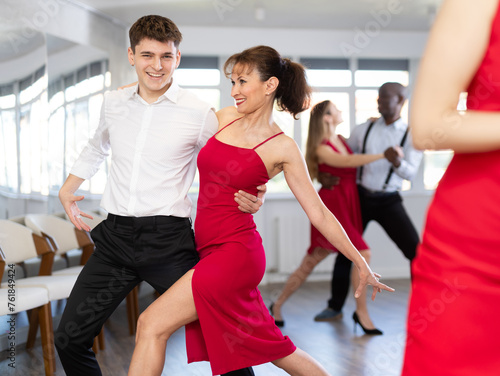 Energy man and woman are dancing tango in couple during lesson at studio. Leisure activities and physical activity for positive people.