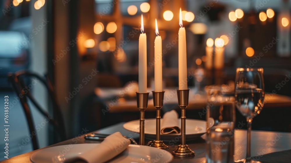 Tall candle-holders with thin candles in them stand on dinner table - obrazy, fototapety, plakaty 