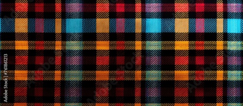 A closeup of a vibrant Tartan plaid pattern in electric blue and magenta on a black textile background, showcasing the symmetry and composite material with various tints and shades