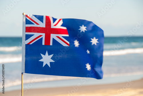 Discover the pride of Australia with a small flag adorning Moreton Island's Queensland beach. A patriotic touch amidst coastal beauty photo