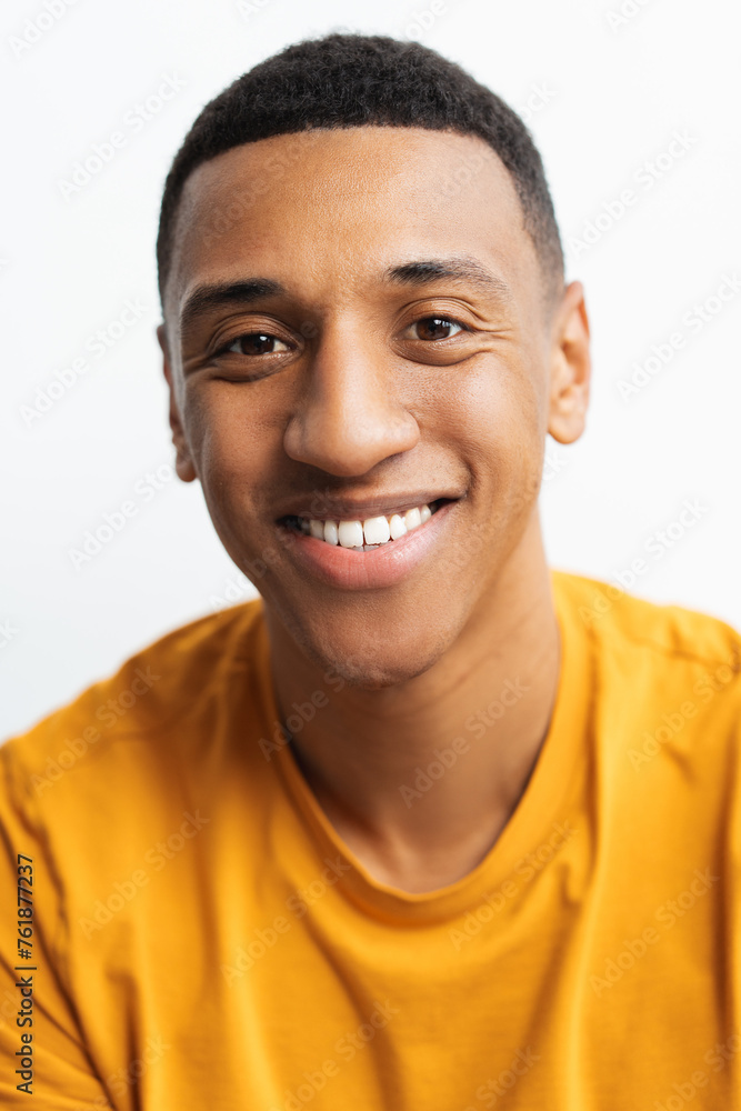 Portrait of attractive, smiling African American man looking at camera closeup Portrait of attractive, smiling African American man looking at camera closeup