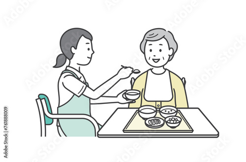 食事介助をする介護士と高齢女性のイラスト