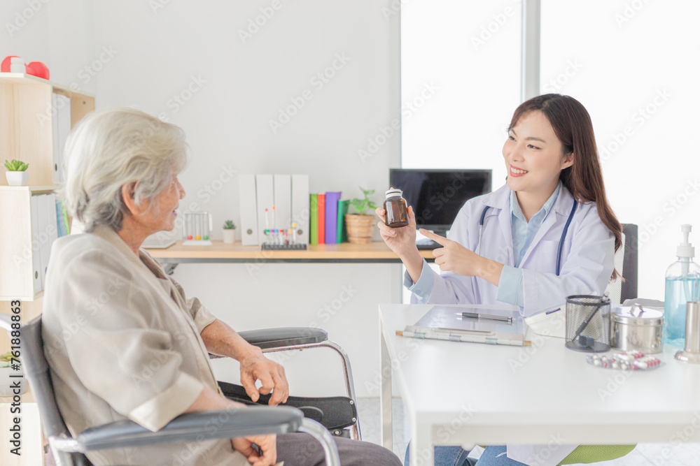 asian female doctor explaining about how to use drug and supplementary food with old patient in hospital, elderly disease treatment, she holding amber glass bottle with hand asian female doctor explaining about how to use drug and supplementary food with old patient in hospital, elderly disease treatment, she holding amber glass bottle with hand