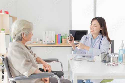 asian female doctor explaining about how to use drug and supplementary food with old patient in hospital, elderly disease treatment, she holding amber glass bottle with hand
