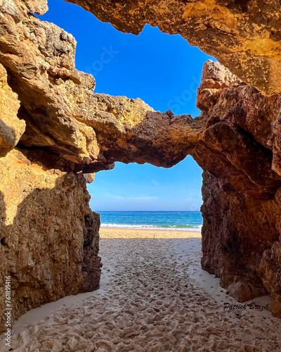 Natural arch formation on Praia das Furnas beach in Algarve, Portugal coastline