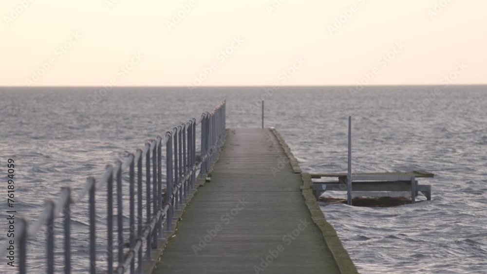 Empty Concrete Dock In The Ocean During Sunset. - zoom out Empty Concrete Dock In The Ocean During Sunset. - zoom out