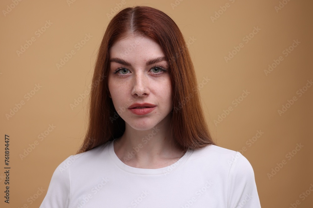 Portrait of beautiful woman with freckles on beige background Portrait of beautiful woman with freckles on beige background