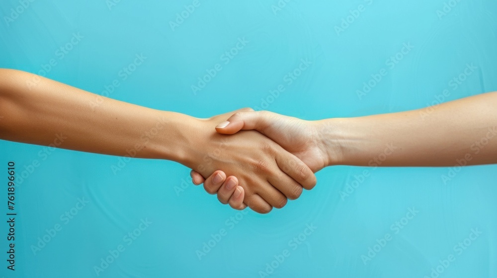 A handshake isolated on a blue background is a concept of relationships, teamwork, partnership deals, businessman cooperation, corporate meetings, contracts, friendship and business agreements. A handshake isolated on a blue background is a concept of relationships, teamwork, partnership deals, businessman cooperation, corporate meetings, contracts, friendship and business agreements.