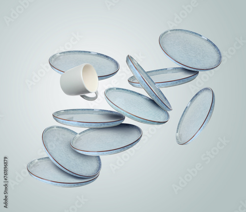 Clean plates and cup falling on light dusty blue background