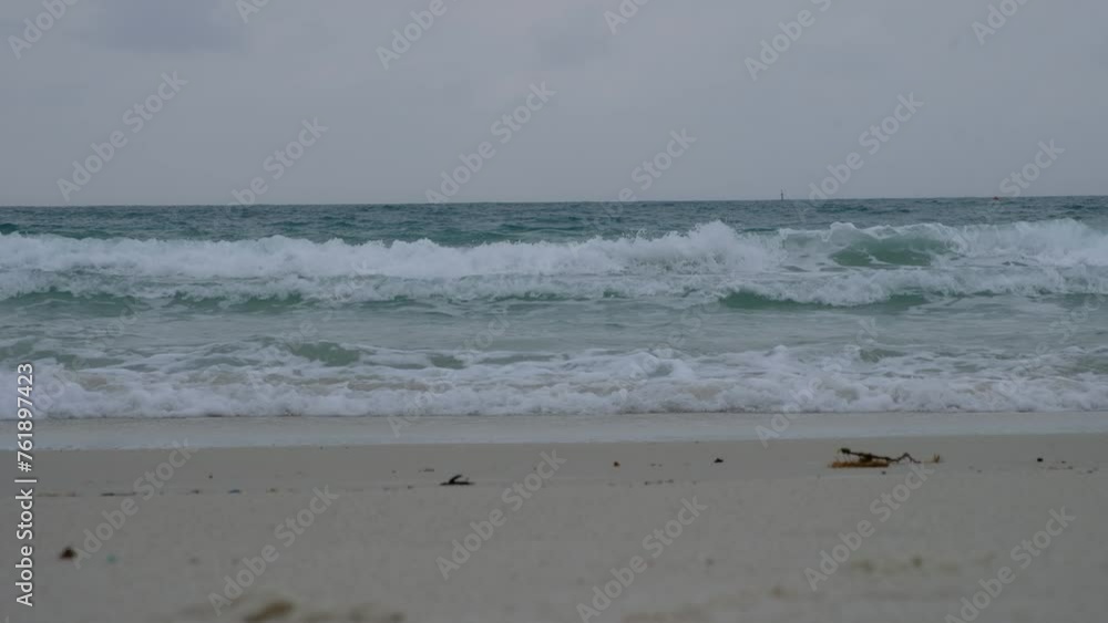 Ocean waves are hitting the shore in the morning when it is about to rain. Ocean waves are hitting the shore in the morning when it is about to rain.