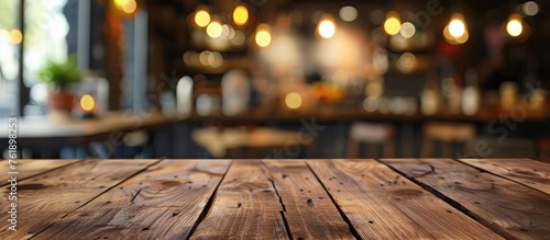Focus on a brown wooden table with a blurred Coffee shop background for product display montage.