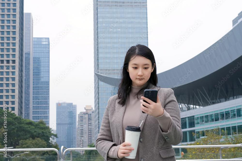 Businesswoman Checking Smartphone in Urban Setting