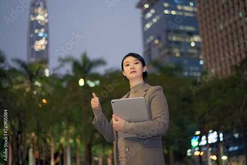 Confident Businesswoman with Tablet Giving Thumbs Up Outdoors
