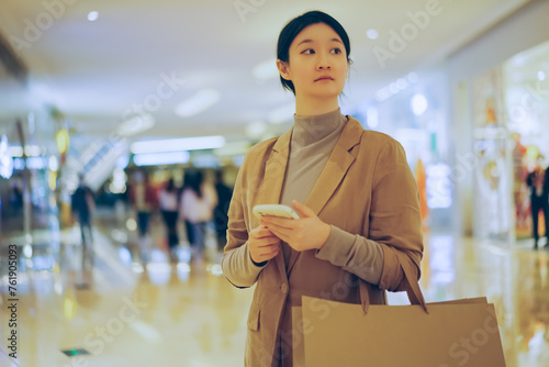 Young Woman Using Smartphone During Shopping Spree