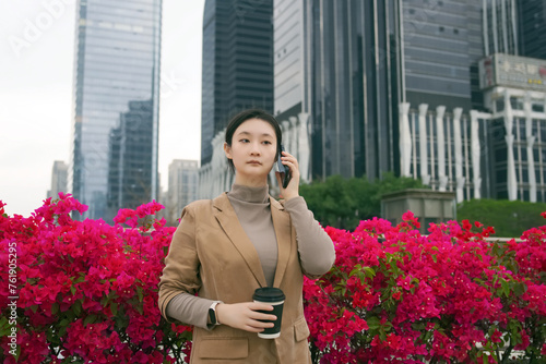 Young Businesswoman On Call Amidst City Blooms