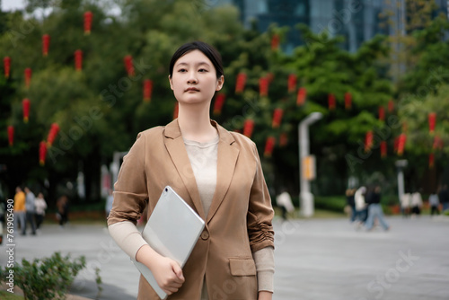 Confident Businesswoman Walking in City Park © 昊 周