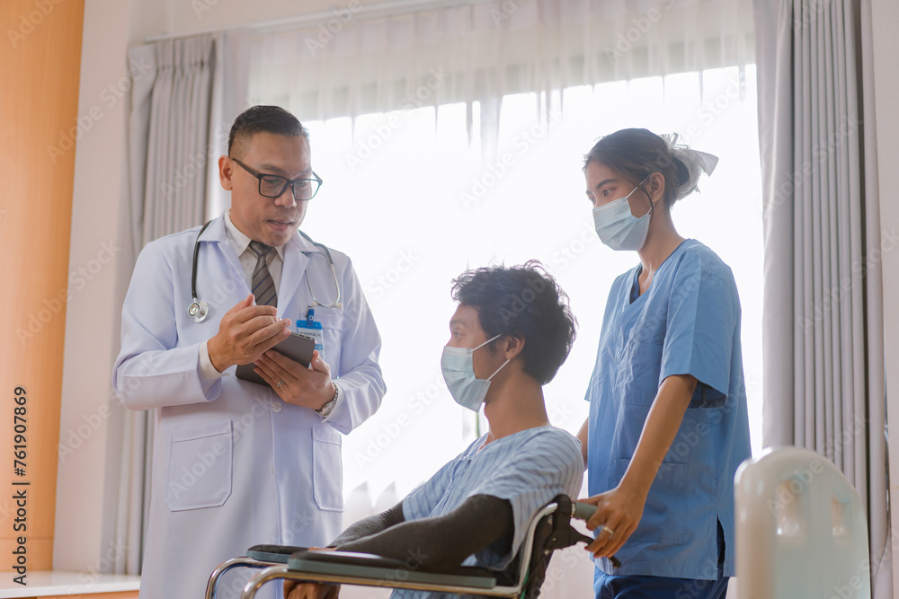 Doctor checking blood pressure to a patient. The doctor is inserting a device into the arm to measure blood pressure for a physical examination. Doctor checking blood pressure to a patient. The doctor is inserting a device into the arm to measure blood pressure for a physical examination.