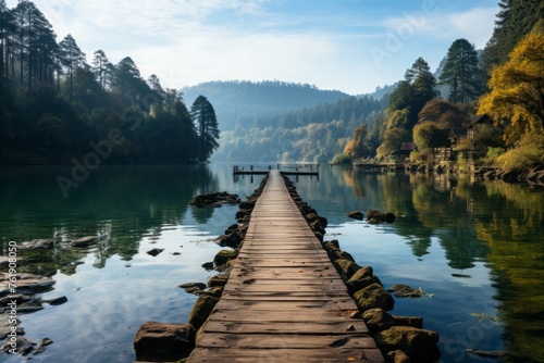 Wooden dock over water, surrounded by trees in natural landscape