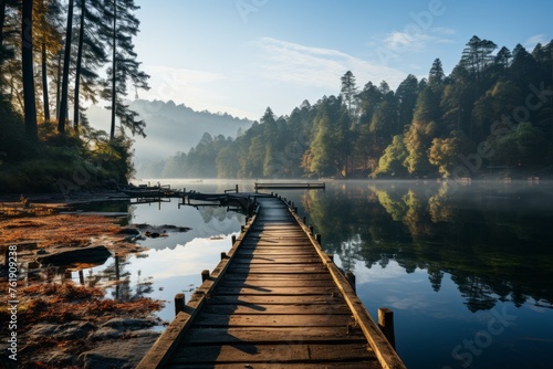 A wooden dock on a serene lake surrounded by trees under a cloudy sky
