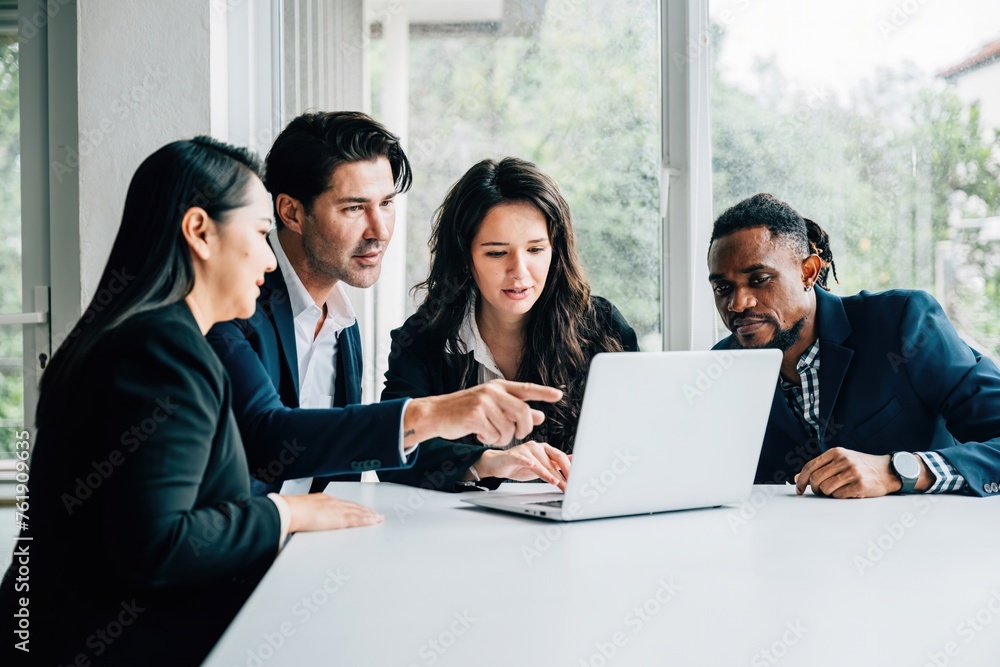 Diverse business professionals, both men and women, work together in meeting room using laptop. Their teamwork, collaboration, diversity are apparent they discuss, plan, and strategize for success. Diverse business professionals, both men and women, work together in meeting room using laptop. Their teamwork, collaboration, diversity are apparent they discuss, plan, and strategize for success.