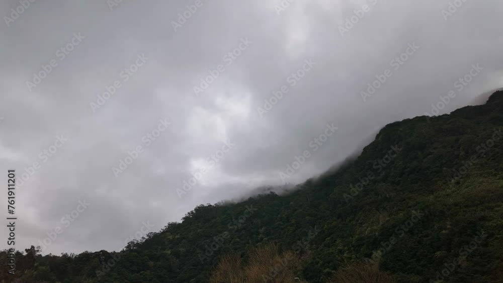 Motion lapse of heavy Clouds moving fast over Forested Mountain in Madeira Island Motion lapse of heavy Clouds moving fast over Forested Mountain in Madeira Island