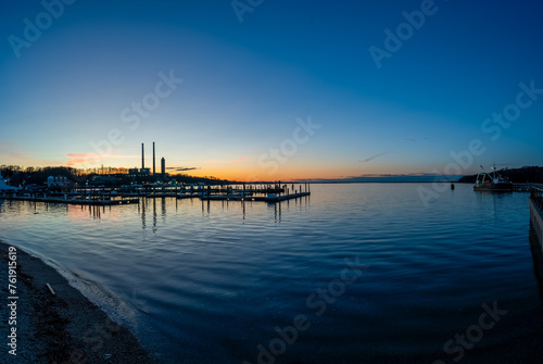 Marvel at the beauty of Port Jefferson Marina at sunset  showcasing the serene marina life with boats docked in calm waters under a breathtaking sky  reflecting the unique charm of Long Island.