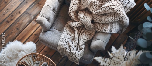 Obraz na płótnie Knitted sweater on armchair in warm and cozy living room, top view w salonie