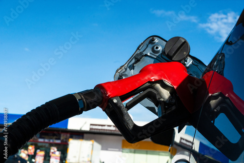 Fuel oil gasoline dispenser at petrol filling station. Fuel nozzle to refuel gasoline for car.