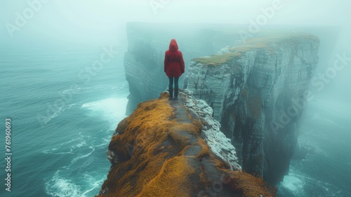 A woman stands at the edge of a cliff overlooking a vast ocean. The path to enlightenment can sometimes feel like a leap of faith with all uncertainty and potential for growth.