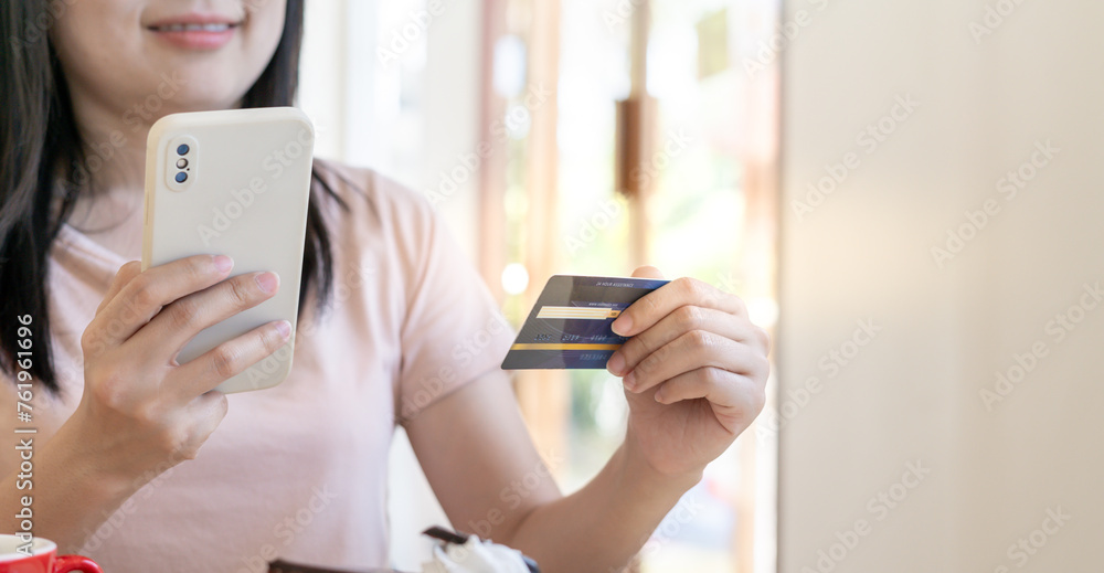 woman using smartphone for online shopping at home. Hand holding mobile phone with payment detail page display and credit card, stay home, technology, electronic commerce, internet, market place woman using smartphone for online shopping at home. Hand holding mobile phone with payment detail page display and credit card, stay home, technology, electronic commerce, internet, market place