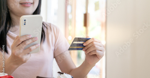woman using smartphone for online shopping at home. Hand holding mobile phone with payment detail page display and credit card, stay home, technology, electronic commerce, internet, market place