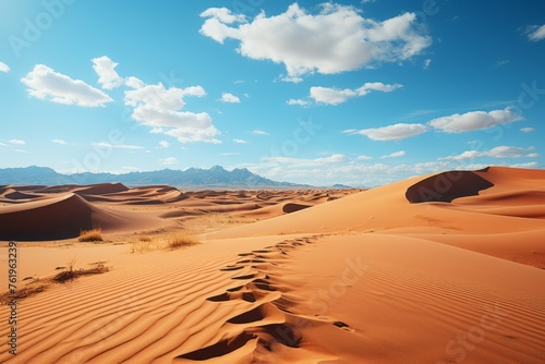 Footprints in desert sand under cloudy sky, natural aeolian landscape