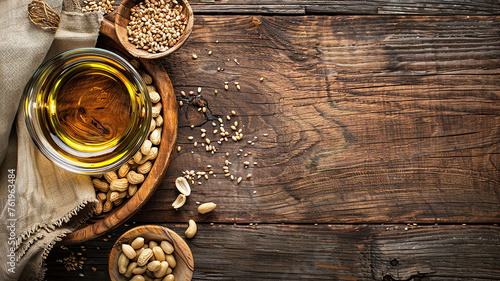 Bowl of peanut oil on wooden table with empty space for copying. Food background.