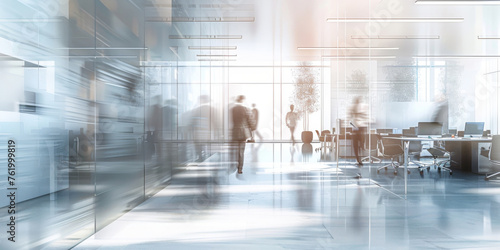 This photo captures a blurred image of people walking in an office setting. The individuals appear to be busy and on the move within the workplace environment photo