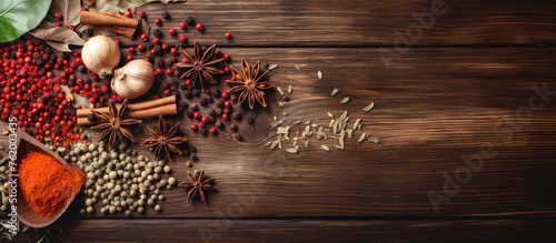 Spices and herbs arranged on a wooden table photo