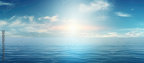 Tranquil Seascape with Fluffy Clouds and Radiant Sun Over Blue Ocean Horizon