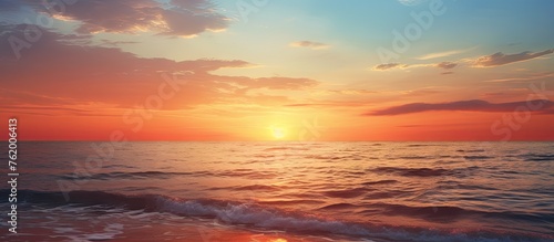 Serene Sunset Casting Vibrant Colors on the Calm Ocean Waves © Ilgun