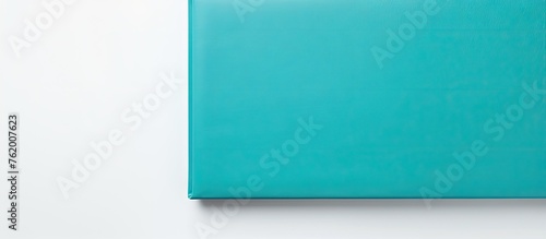 A blue book on a white surface photo