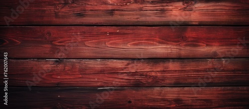 A close up of a wooden wall with red paint