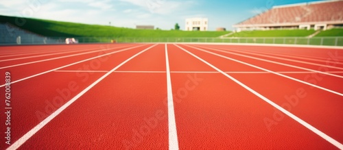 Vibrant Red Running Track Beneath Clear Blue Sky for Summer Fitness Training