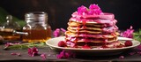 A delicious pancake stack with raspberry syrup