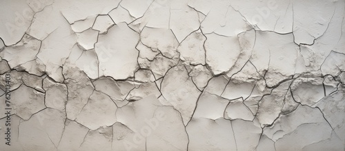 A close up of a weathered white wall