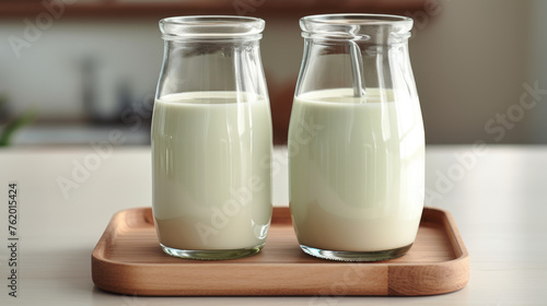 Milk products, tasty and healthy dairy products. 3 Bottles and glasses of milk on wooden table.