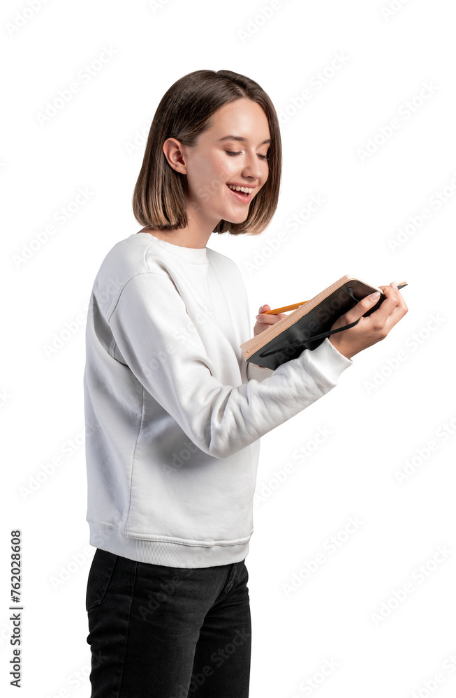 A woman in casual wear smiling while using a notepad, photographed against a white background. Lifestyle and study concept A woman in casual wear smiling while using a notepad, photographed against a white background. Lifestyle and study concept