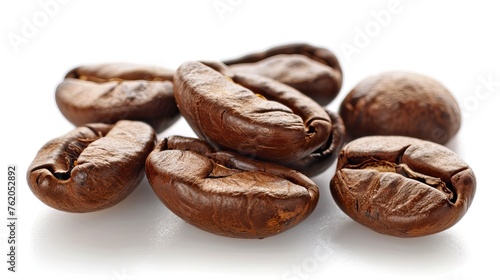 Close up of roasted coffee beans with rich texture against a white background
